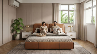 Couple relaxing on a brown upholstered bed with neutral bedding in a bright Singapore bedroom with soft curtains and plants