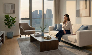 Modern condo living room in Singapore with cream sofa, coffee table, accent chair and city view for online furniture shopping guide