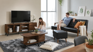 Otto living room furniture set in a modern Singapore home, with a black sofa, ottoman, TV console, and coffee table styled for everyday comfort.
