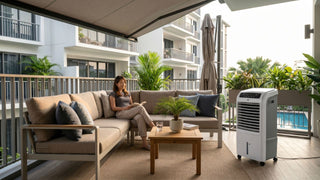 Outdoor air cooler beside a beige balcony sofa in a Singapore condo patio seating area.