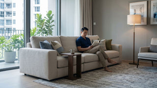 Performance fabric sofa in a Singapore condo living room with balcony plants and neutral decor