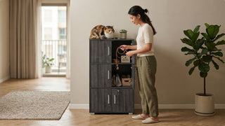 Woman organising pet supplies in a dark storage cabinet with a cat in a modern Singapore home