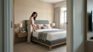 Queen bed frame in a compact 2-room Flexi HDB bedroom with neutral bedding, bedside table, and clear walking space.