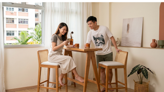 Rattan bar stools at a Singapore kitchen island with warm modern hosting setup