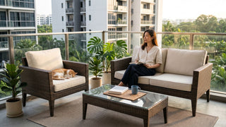 Woman reading on rattan outdoor sofa set with cat on condo balcony in Singapore