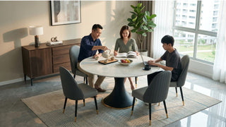 Family using a round quartz dining table for meals, reading, and laptop work in a bright HDB dining space