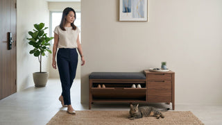 Woman walking past a wooden shoe storage bench with drawers in a Singapore HDB entryway