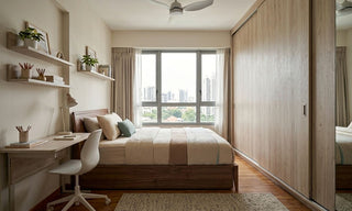 Shoebox children’s room with single bed, wall-mounted study desk, shelves, and large sliding-door wardrobe in a compact Singapore home.
