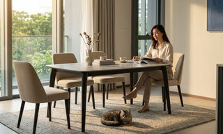 Compact short dining table with upholstered chairs in a bright Singapore condo dining area