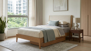 Wooden single bed frame with under-bed storage in a bright Singapore bedroom