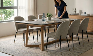 Six upholstered dining chairs around a rectangular dining table in a bright Singapore home.