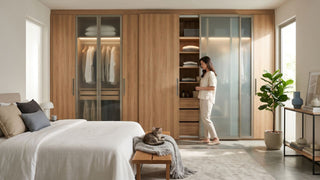 Sliding wardrobe with wood and frosted glass doors in a bright Singapore bedroom