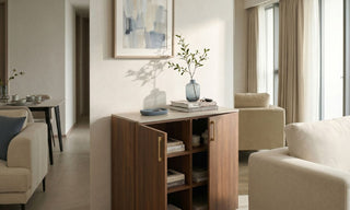 Slim wooden storage cabinet with open shelves in a warm Singapore condo living and dining area.