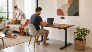MegaFurniture smart desk in a modern Singapore home office with a family using the living room nearby.