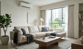 Split type aircon installed above a beige sofa in a bright Singapore condo living room.