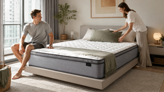 Spring mattress in a bright modern Singapore bedroom with a couple arranging pillows in a practical home setting.