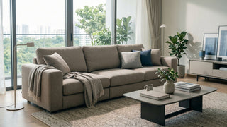 Stain-resistant beige fabric sofa in a bright Singapore condo living room with coffee table, rug and balcony view.