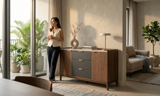 Storage cabinet with drawers in a Singapore living room beside balcony plants and neutral decor.