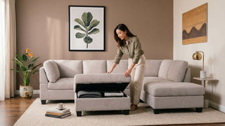 Woman opening a storage ottoman in a small Singapore living room with beige sectional sofa and warm neutral decor