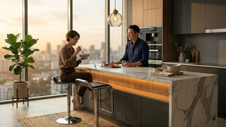 Couple dining on black swivel chairs at a marble kitchen island in a modern high-rise Singapore home