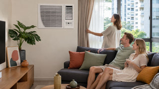 System 1 aircon in a modern Singapore condo living room with a family relaxing near the window