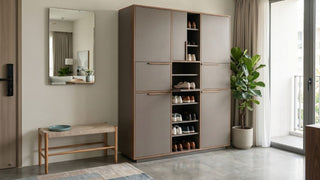 Tall shoe cabinet with open shelves in a modern Singapore HDB entryway with mirror, bench, and indoor plant.
