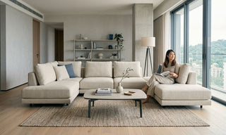 Beige tatami sofa in a bright Singapore condo living room with large windows and modern neutral decor.