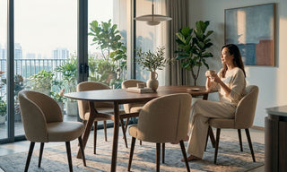 Upholstered dining chairs around a wooden dining table in a bright Singapore condo dining room with balcony plants.