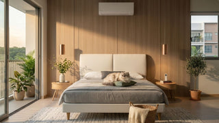 Wall-mounted air conditioner in a warm Singapore bedroom with upholstered bed, cat, balcony view, plants, and wooden feature wall