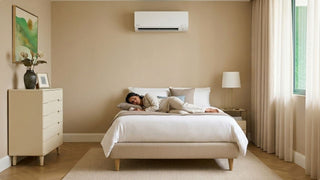 Woman resting on a bed under a wall-mounted aircon in a calm bedroom