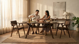 Warm modern dining room with wooden table, upholstered chairs and natural light