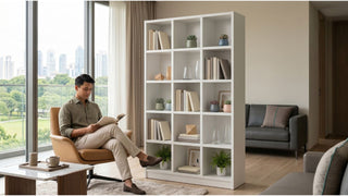 White bookshelf separating a cosy reading corner from the living area in a modern Singapore home