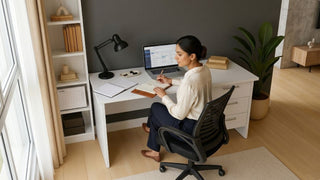 Woman planning work at a white desk with storage in a compact Singapore home office corner