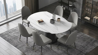 White retractable dining table with grey chairs in a modern Singapore dining room with display cabinet and city view