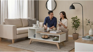 Couple enjoying coffee beside a white and wood coffee table in a cosy Singapore condo living room