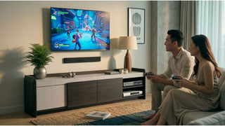 Couple gaming in a cosy living room with a wide TV console, soundbar, and open media storage