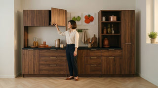 Woman reaching for wood kitchen top cabinet in a modern Singapore kitchen with open shelving