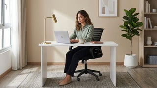 Woman using a white study desk with office chair in a calm Singapore home office