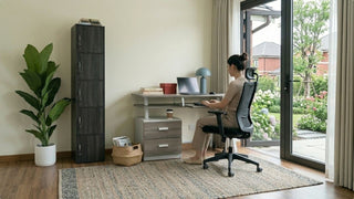 Woman working at a desk with filing cabinet in a bright landed home study