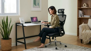 Woman working at a slim study table with ergonomic chair in a bright Singapore home office