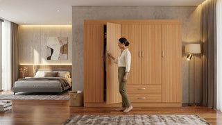 Wooden armoire closet with hinged doors and drawers in a modern bedroom setting