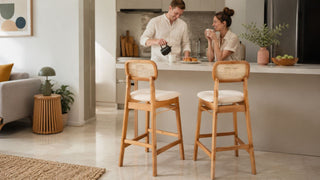 Wooden bar stools with cane backrests at a modern Singapore kitchen counter for a relaxed home breakfast setting.