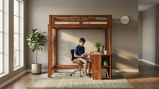 Boy reading at a wooden single bunk bed with desk in a cosy study bedroom
