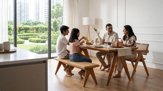 Wooden dining bench paired with a modern dining table in a bright Singapore home dining area with garden views