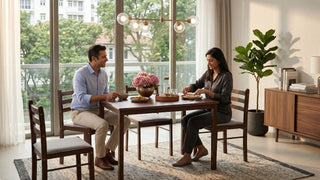Couple using a wooden dining set in a bright Singapore dining room with cushioned chairs, pendant light, sideboard, and balcony view