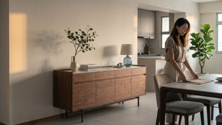 Wooden kitchen sideboard in a Singapore dining area with warm lighting, styled decor, and open kitchen background.