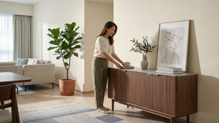 Wooden sideboard styled in a Singapore dining and living room with decor and storage space