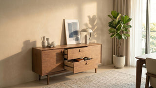 Wooden TV console with open drawers in a warm Singapore living room with natural light and indoor plant.