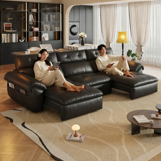 Black leather power sofa bed in a living room