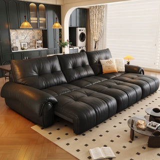 Black leather power sofa bed in a living room